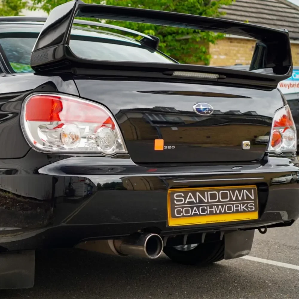 A rear of a Black car repaired by our Subaru Body Shop