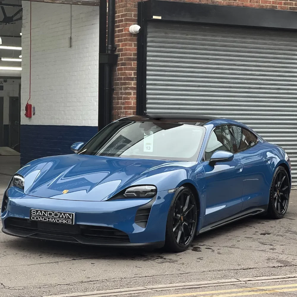 a blue porsche parked outside of our Body shop Henley