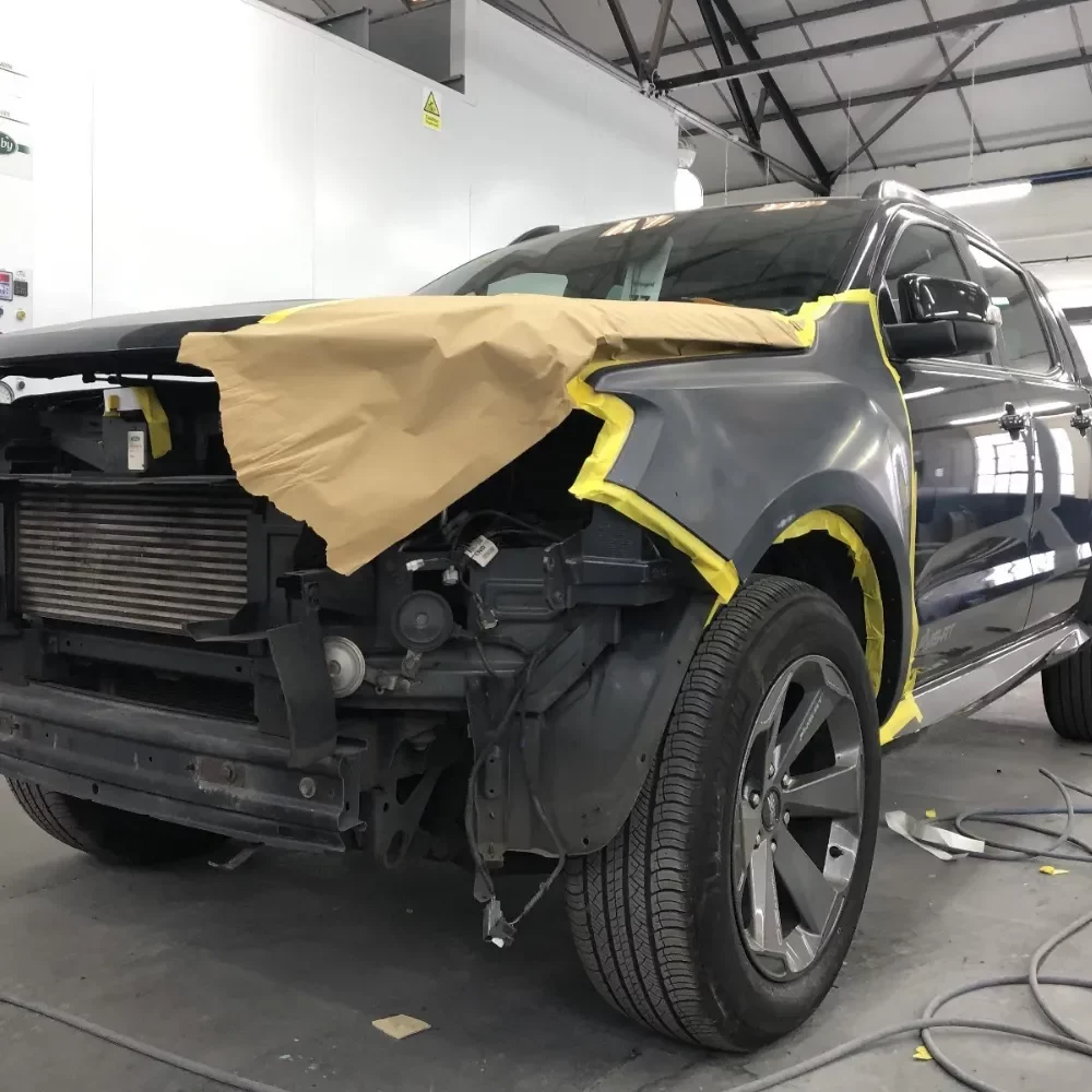 Vehicle in repair shop demonstrating Bumper Repair Near me