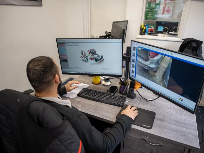 Expert technician at Sandown Coachworks Camberley using Audatex estimating software for a prestige vehicle repair.