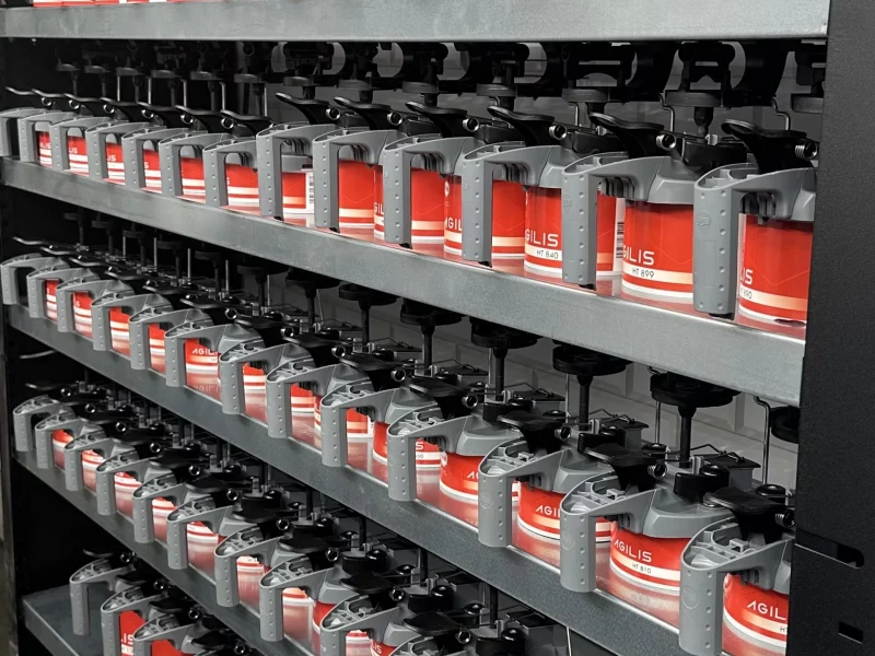 A professional BASF Agilis R-M paint mixing rack at Sandown Coachworks Shepperton, featuring rows of waterborne automotive paint toners for precision colour matching.