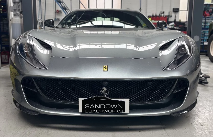 Front view of a silver Ferrari 812 Superfast inside the Sandown Coachworks prestige bodyshop facility in Camberley.