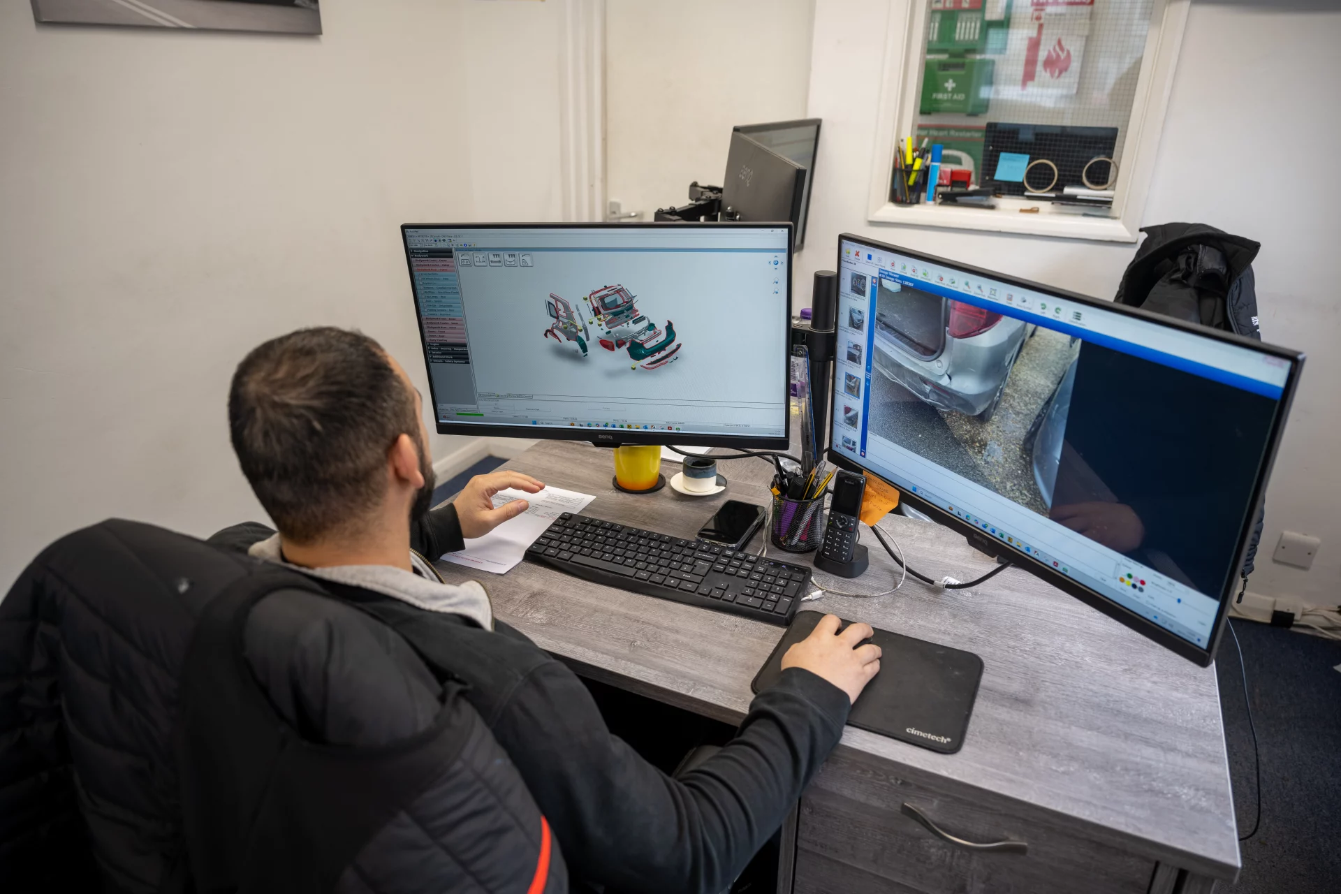 Expert technician at Sandown Coachworks Camberley using Audatex estimating software for a prestige vehicle repair.