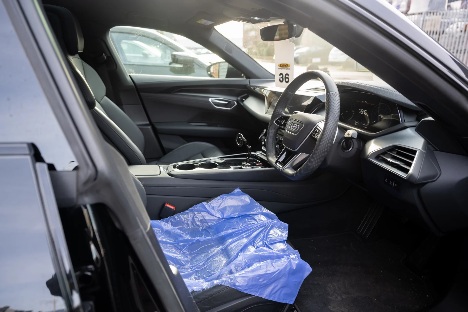 Interior of a luxury Audi at Sandown Coachworks with protective seat covers, demonstrating high standards of vehicle care during the bodywork repair process.