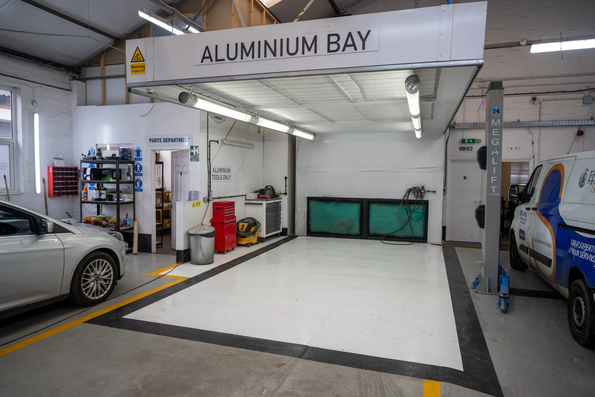 A dedicated, clean-room Aluminium Bay at Sandown Coachworks workshop, featuring specialist extraction and tooling for Audi, Tesla, and Land Rover repairs.